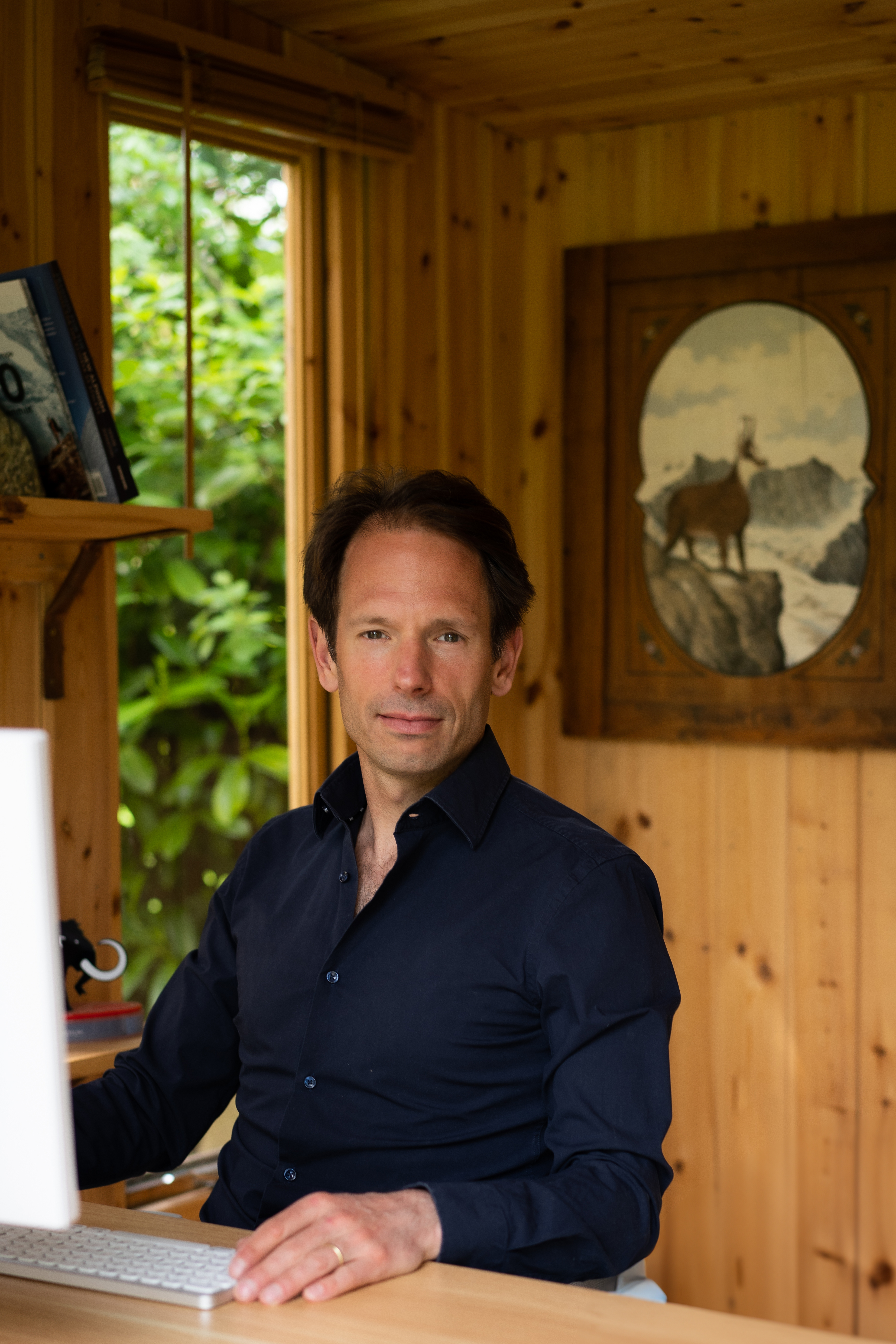 Greg working on his laptop with AI tools